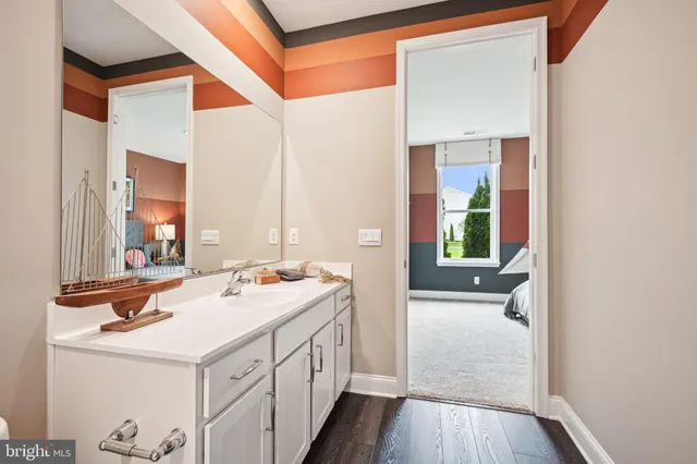 a bathroom with a sink a mirror and a bathtub