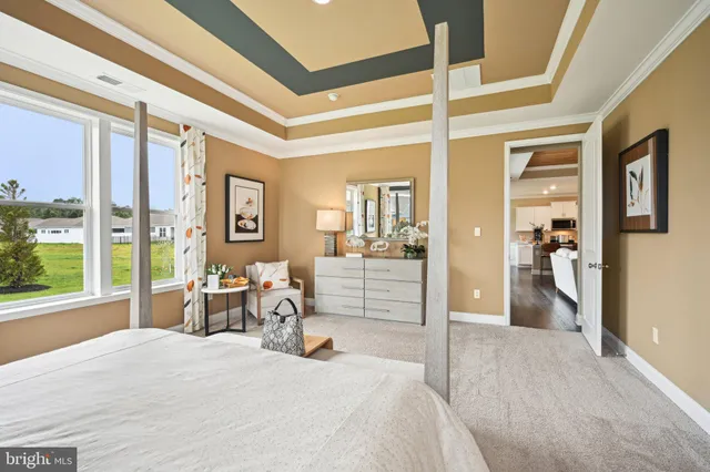 a bedroom with furniture and large window