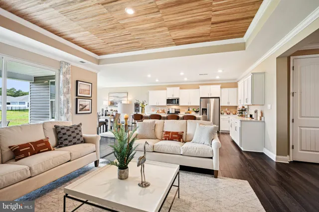 a living room with furniture white walls and wooden floor