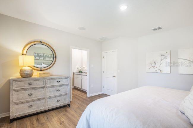 1407 Needle Palm Drive Edgewater, FL 32132 - Photo 11 of 28 a bedroom with a bed and a dresser