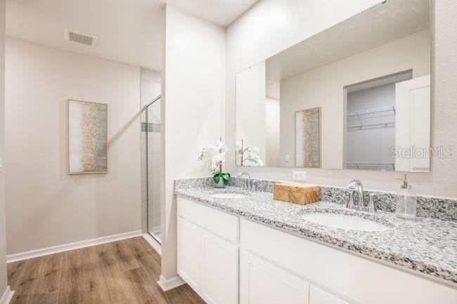 1407 Needle Palm Drive Edgewater, FL 32132 - Photo 13 of 28 a bathroom with a granite countertop sink and a mirror