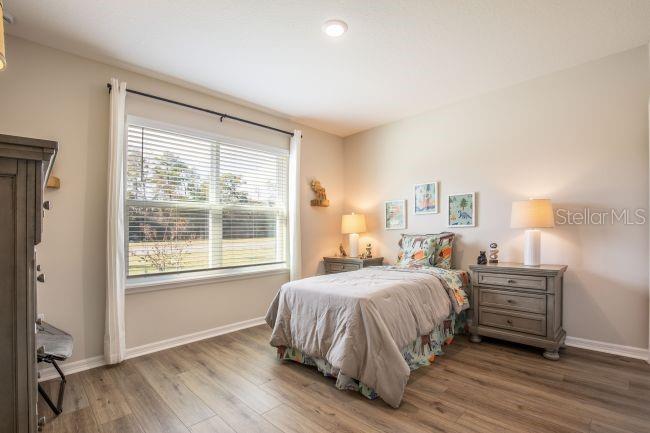 1407 Needle Palm Drive Edgewater, FL 32132 - Photo 14 of 28 a bedroom with a bed a mirror and a window