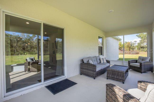1407 Needle Palm Drive Edgewater, FL 32132 - Photo 18 of 28 a living room with furniture and a large window