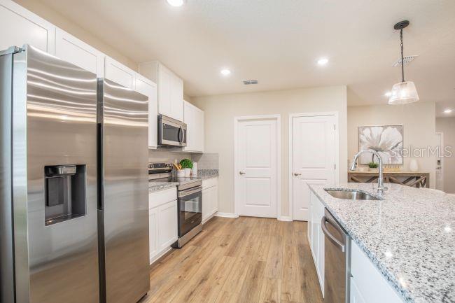 1407 Needle Palm Drive Edgewater, FL 32132 - Photo 7 of 28 a kitchen with a sink stove and refrigerator