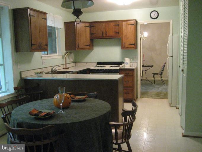 5503 Callander Drive Springfield, VA 22151 - Photo 2 of 28 a kitchen with a sink and a stove with wooden floor