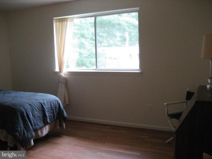 5503 Callander Drive Springfield, VA 22151 - Photo 13 of 28 a bed sitting in a bedroom next to a window