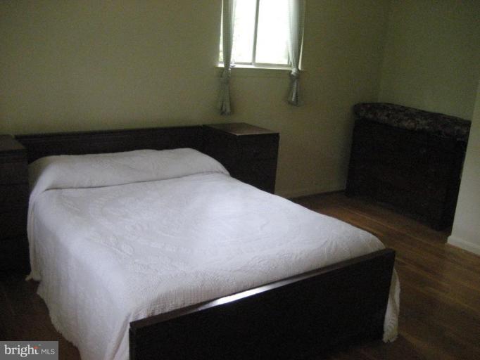 5503 Callander Drive Springfield, VA 22151 - Photo 14 of 28 a bed sitting in a bedroom next to a window