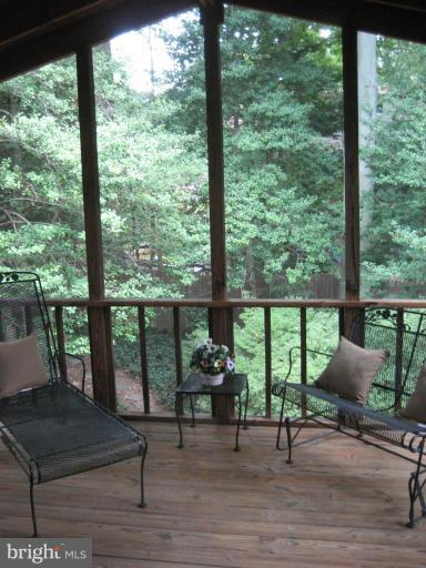 5503 Callander Drive Springfield, VA 22151 - Photo 5 of 28 a view of a living room and floor to ceiling window chair and table in the porch