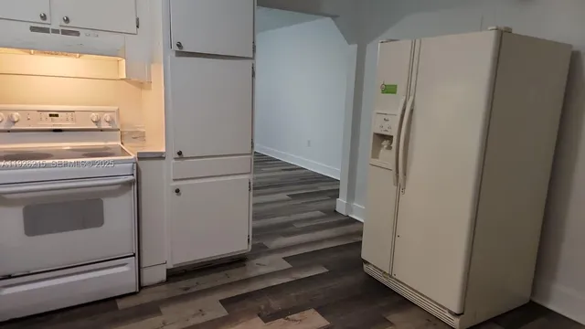 a kitchen with a refrigerator and a stove