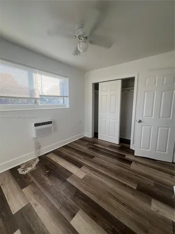 a view of a livingroom with wooden floor and staircase