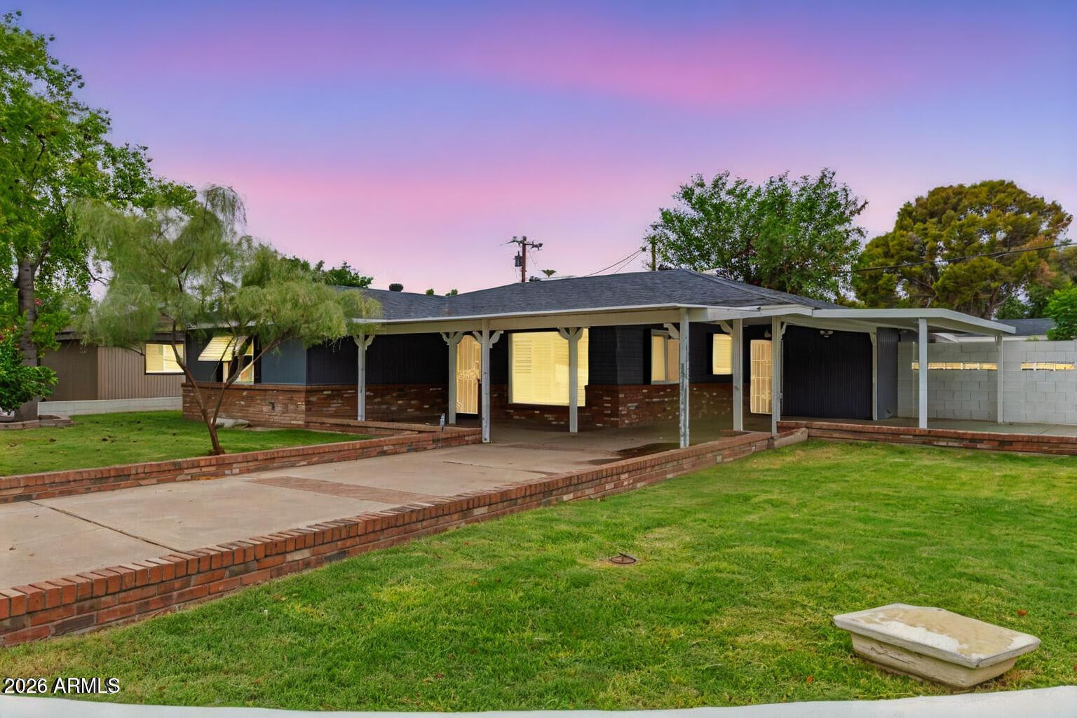 7340 North 7th Avenue Phoenix, AZ 85021 - Photo 1 of 37 a front view of a house with a yard and trees