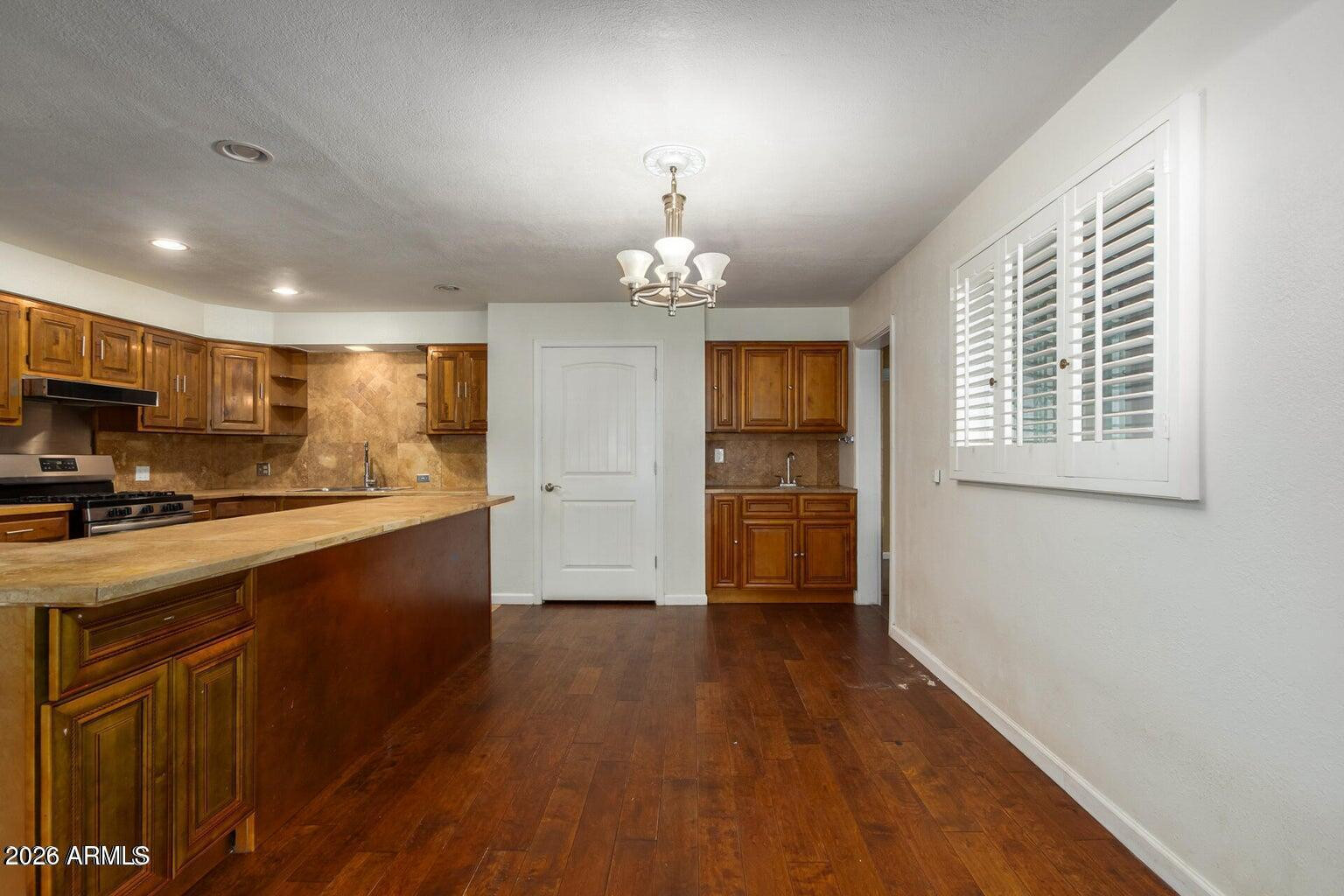 7340 North 7th Avenue Phoenix, AZ 85021 - Photo 11 of 37 a kitchen that has a lot of cabinets and wooden floor