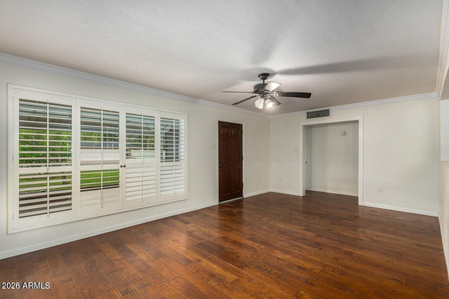 7340 North 7th Avenue Phoenix, AZ 85021 - Photo 14 of 37 a view of an empty room with a window and wooden floor
