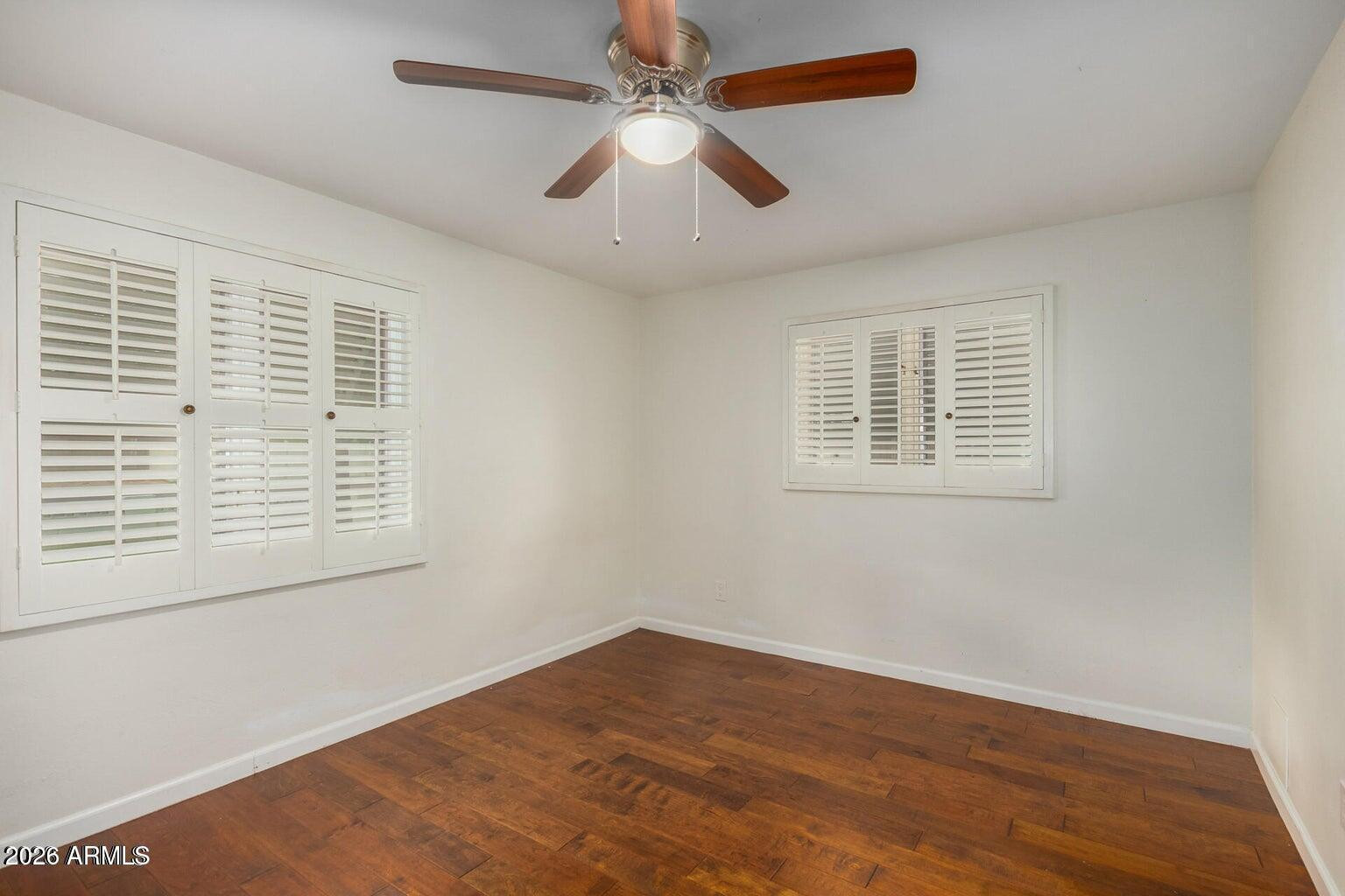 7340 North 7th Avenue Phoenix, AZ 85021 - Photo 23 of 37 a view of an empty room with wooden floor and a window