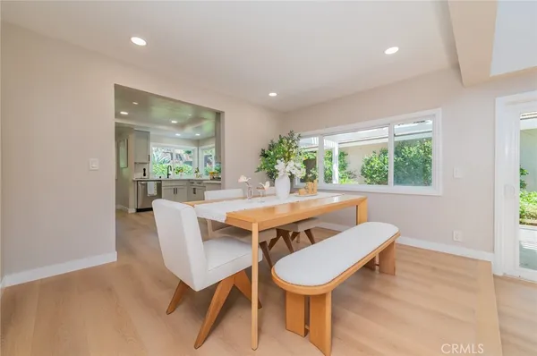 a dining room with furniture and wooden floor