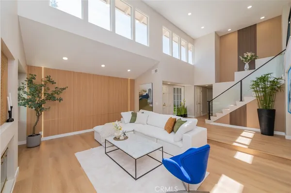 a living room with furniture and flowers