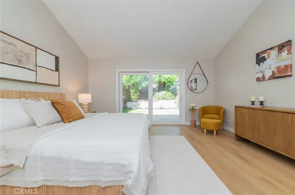 a bedroom with a bed a couch and a window