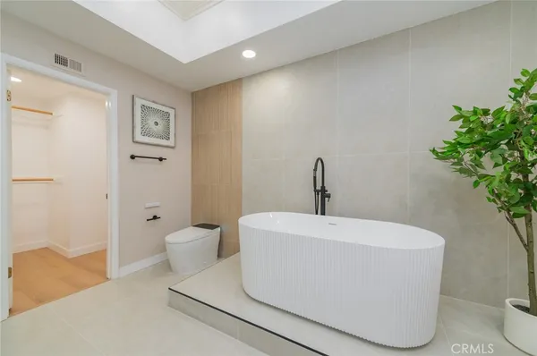 a white bath tub sitting in a bathroom