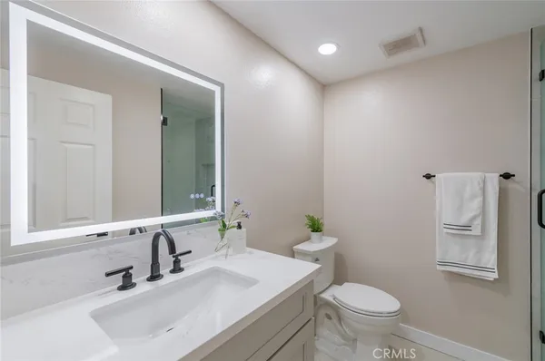 a bathroom with a sink toilet and vanity