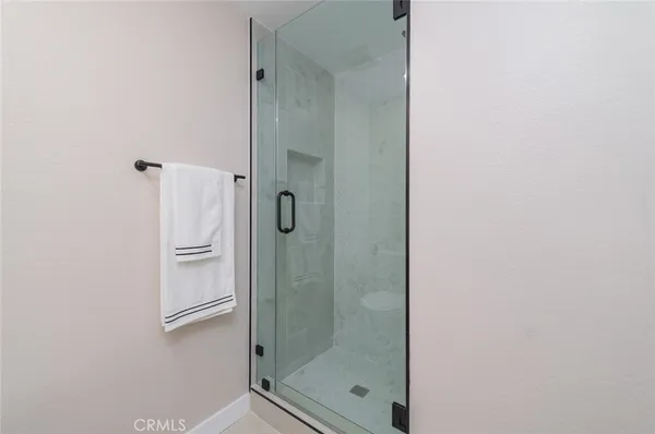 a bathroom with a glass shower door