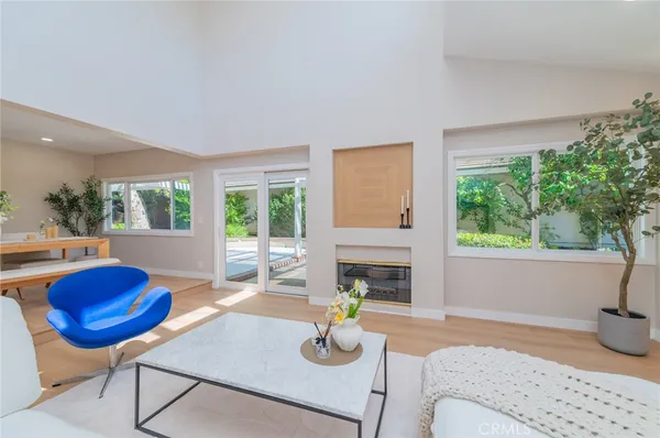 a living room with furniture fireplace and window