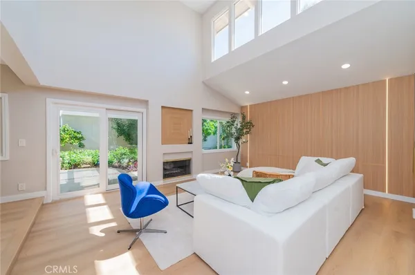 a living room with furniture a rug and a fireplace