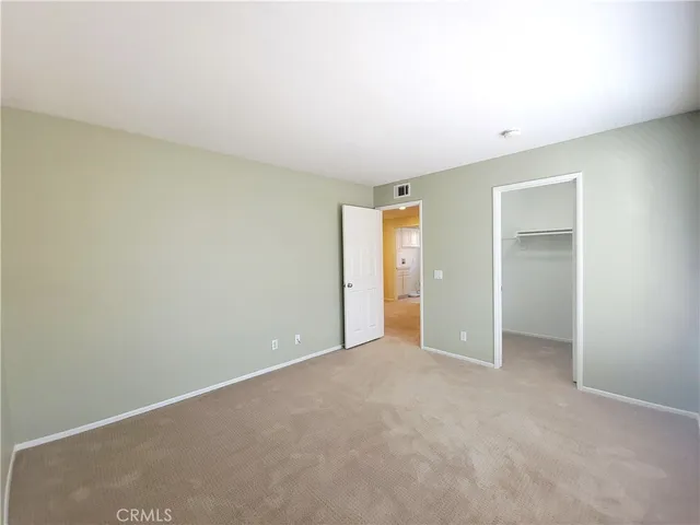 an empty room with closet area