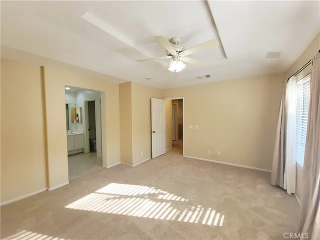 a view of a big room with closet and a chandelier fan