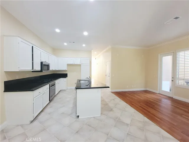 a kitchen with stainless steel appliances a sink and a stove top oven