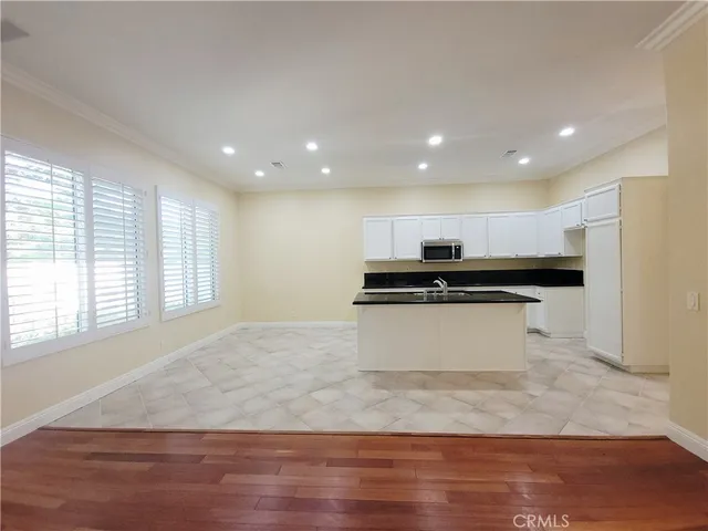 a view of kitchen with granite countertop sink
