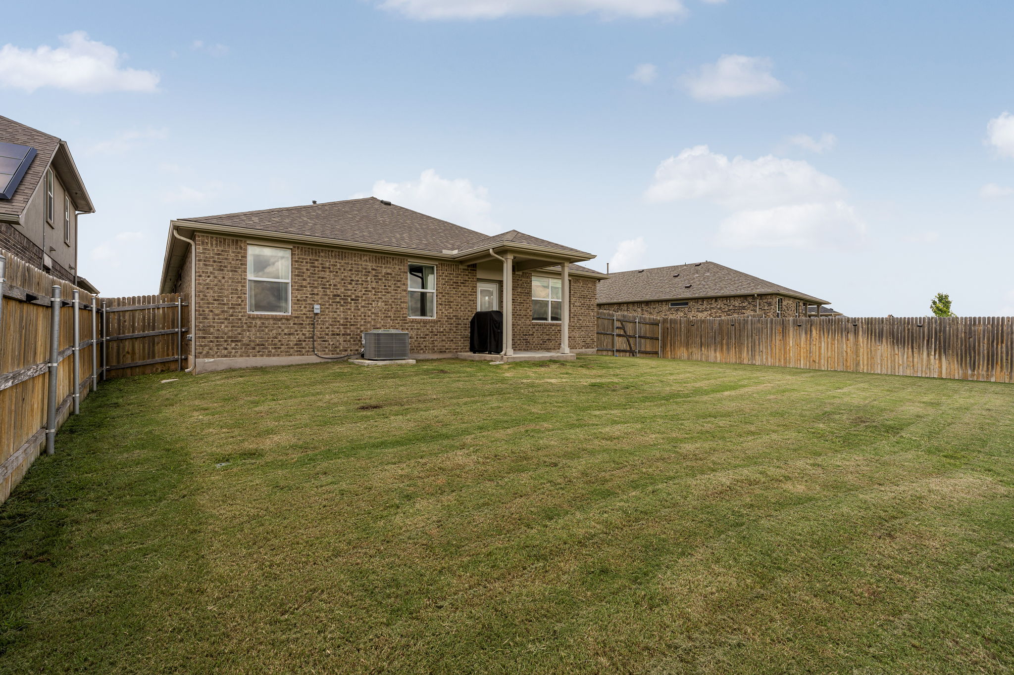 185 Struss Drive Georgetown, TX 78626 - Photo 21 of 23 A spacious, verdant yard provides ample outdoor living space, enclosed by a privacy fence.
