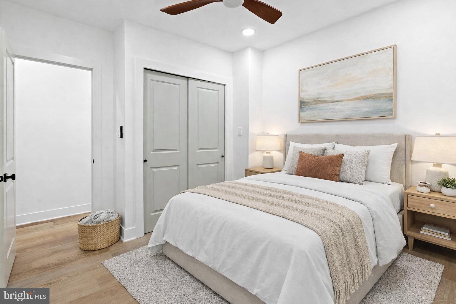 1502 South 52nd Street, Unit A Philadelphia, PA 19143 - Photo 9 of 13 a bedroom with a bed and a painting on the wall