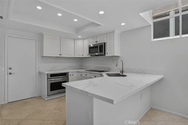 a kitchen with a stove a sink and a microwave