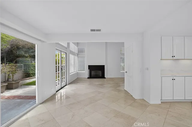 a view of a big room with windows and chandelier