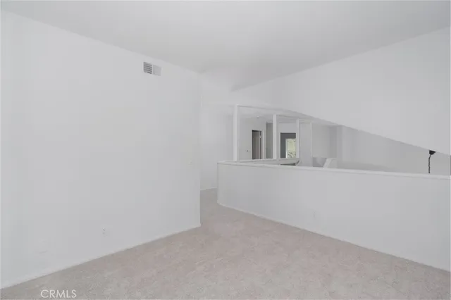 a view of an empty room with closet