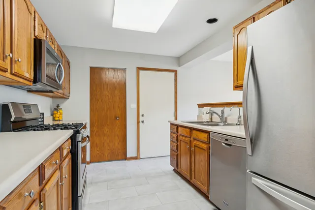 a kitchen with stainless steel appliances granite countertop a refrigerator and a sink