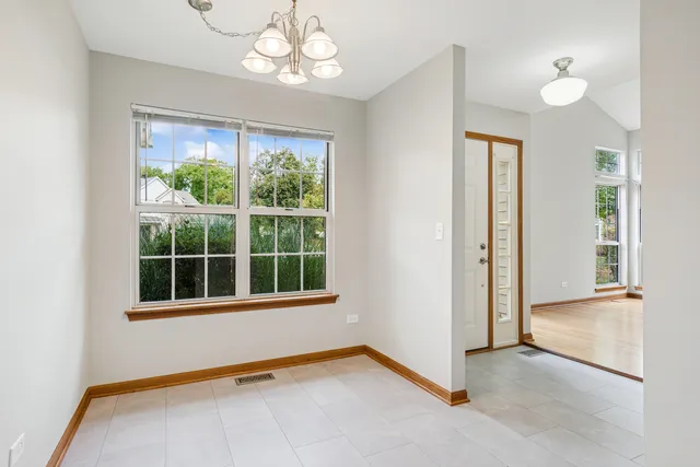 an empty room with windows and entrance