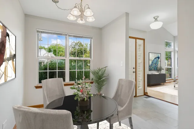 a dining room with furniture a chandelier and window