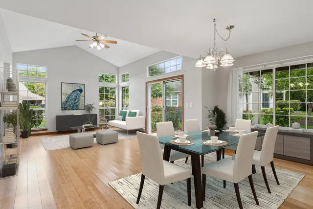 a view of a dining room with furniture wooden floor and chandelier