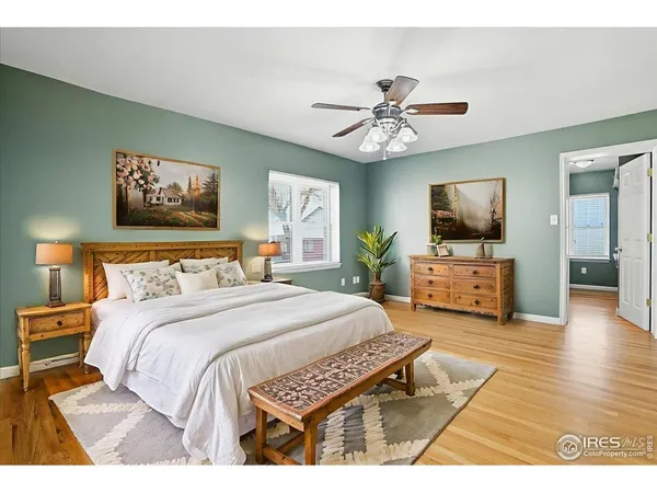 a spacious bedroom with a bed and a flat screen tv
