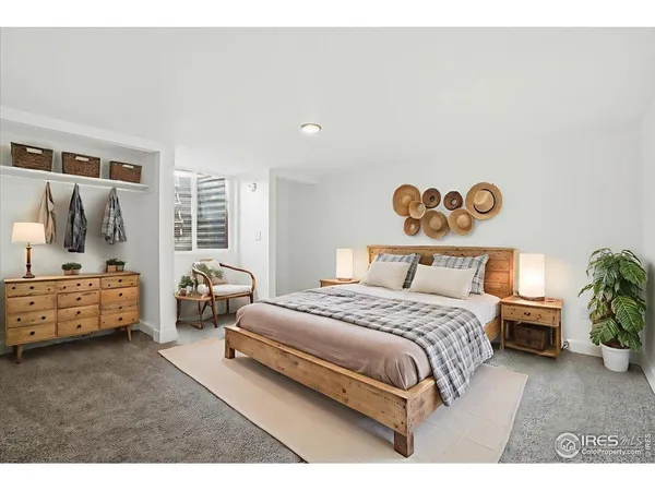 a spacious bedroom with a bed and a couch