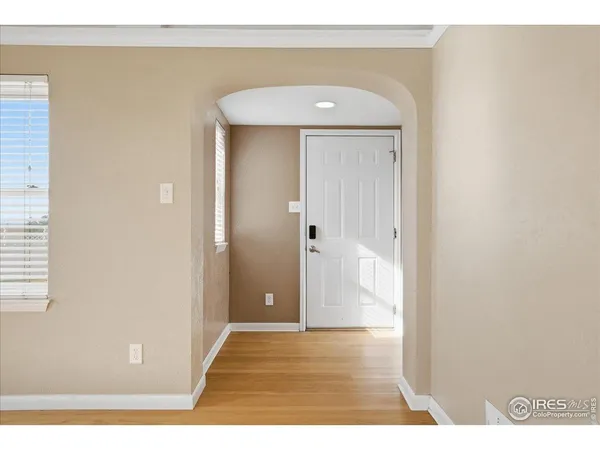 a view of a hallway with wooden floor