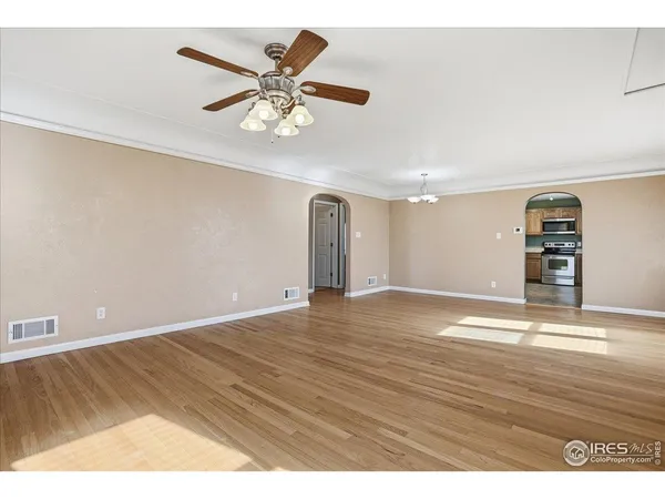 a view of empty room with wooden floor