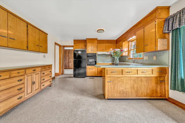 a kitchen with stainless steel appliances granite countertop a sink and cabinets