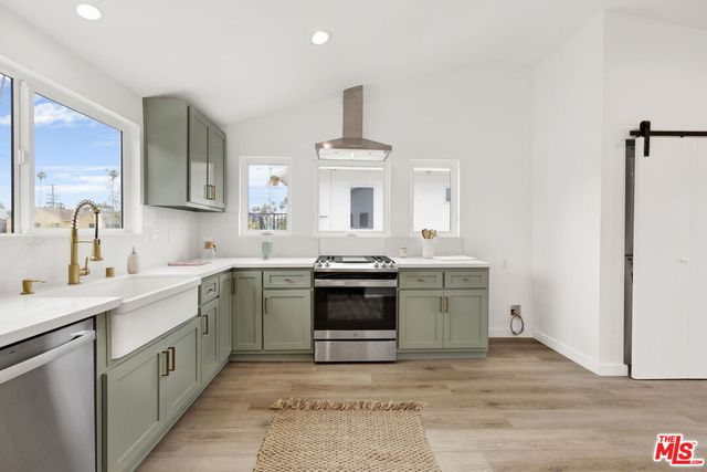 a kitchen with a sink stove and oven
