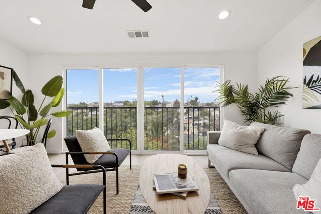 a living room with furniture and a large window