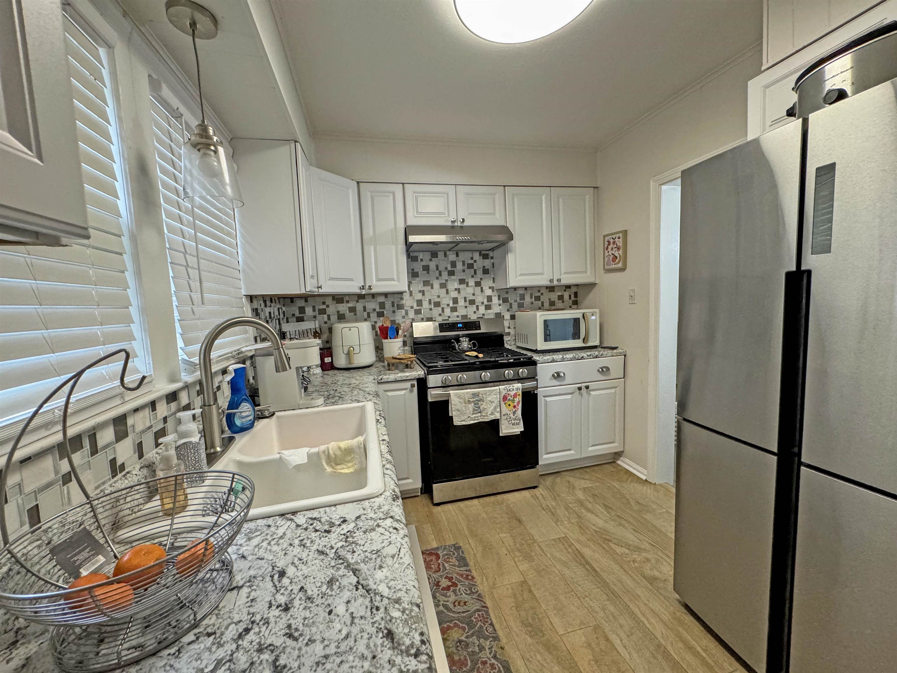 907 Chambliss Road Memphis, TN 38116 - Photo 7 of 23 a kitchen with stainless steel appliances granite countertop a refrigerator sink and stove