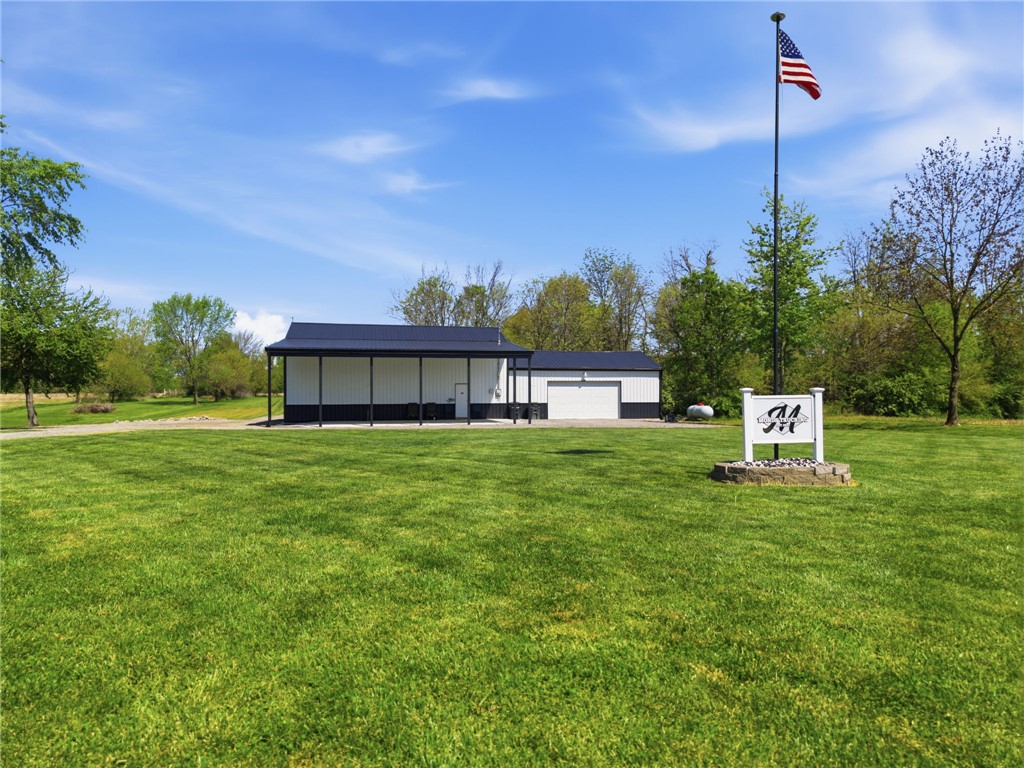 1602 Westboro Road Blanchester, OH 45107 - Photo 69 of 81 This spacious property features a durable metal-roofed structure with an attached carport, offering ample outdoor space.