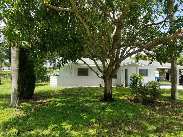 2201 Caladium Road Fort Myers, FL 33905 - Photo 1 of 14 a front view of a house with garden