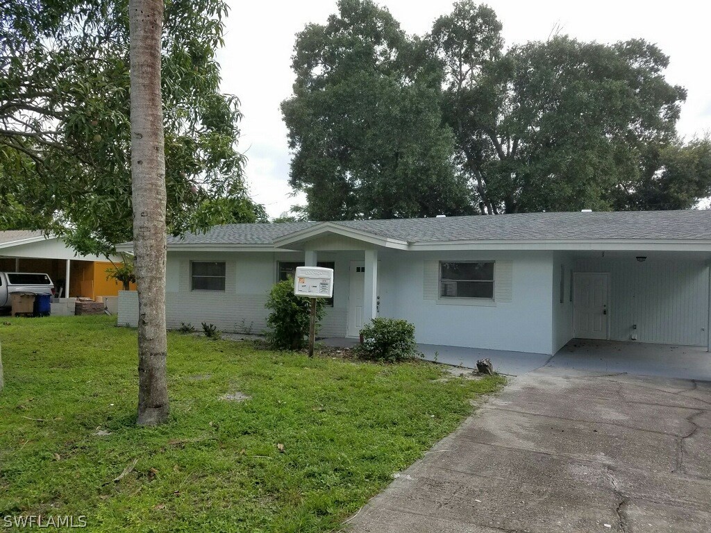 2201 Caladium Road Fort Myers, FL 33905 - Photo 3 of 14 a view of a house with a yard and a large tree